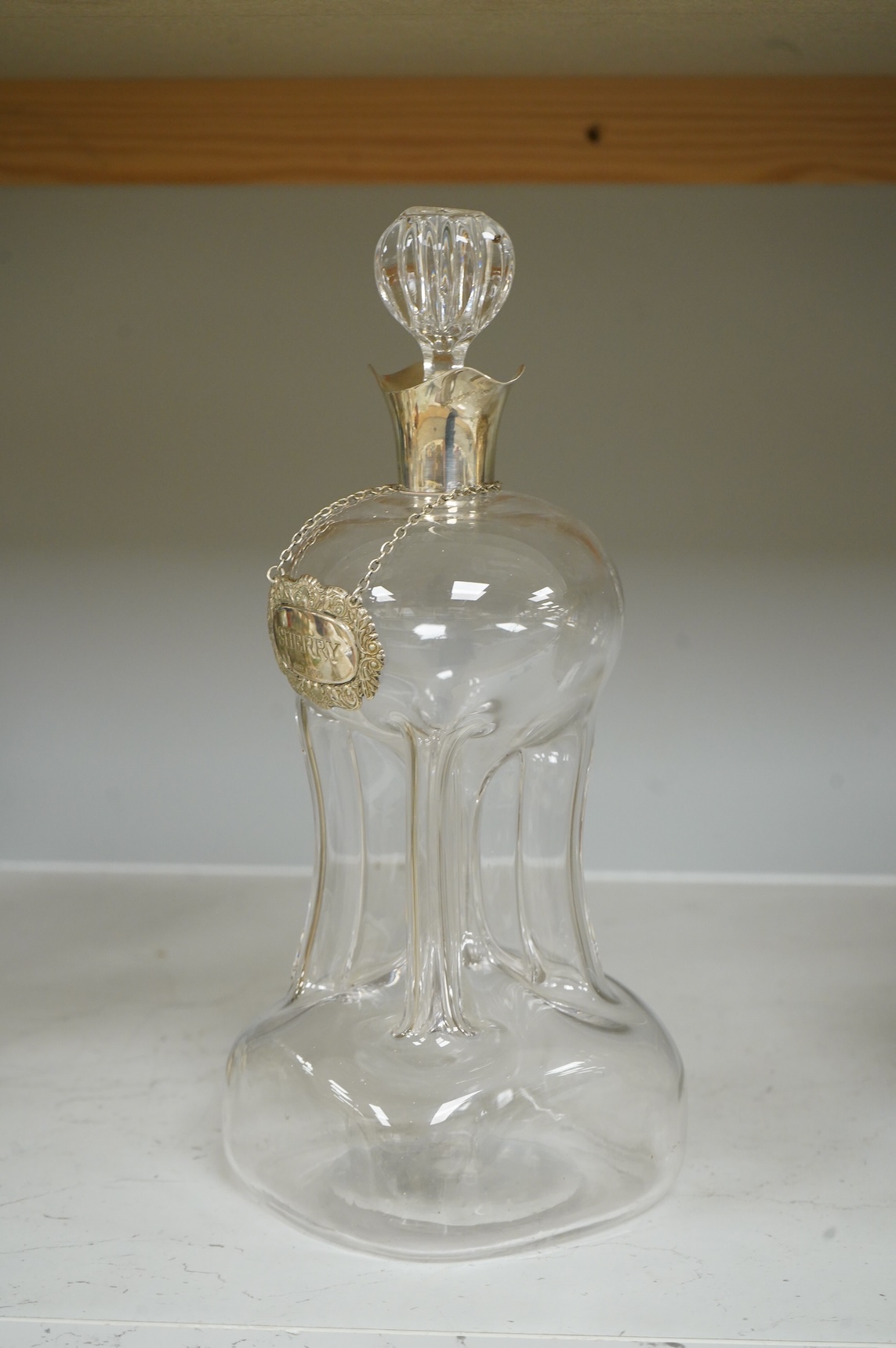 A silver collared glass decanter and ‘sherry’ label, 29cm
